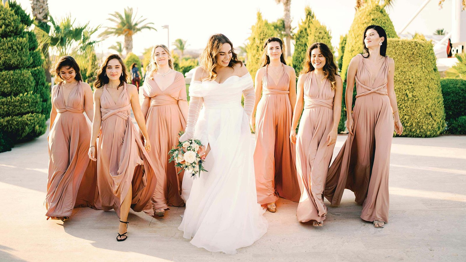 Bride with bridesmaids walking.