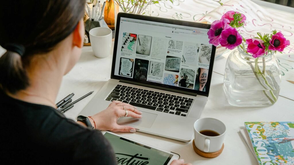 a girl scrolling on a laptop